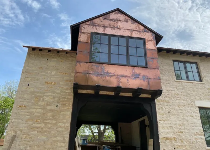 Copper metal panel facade on a stone building for Skylight Installation in Spanish Springs